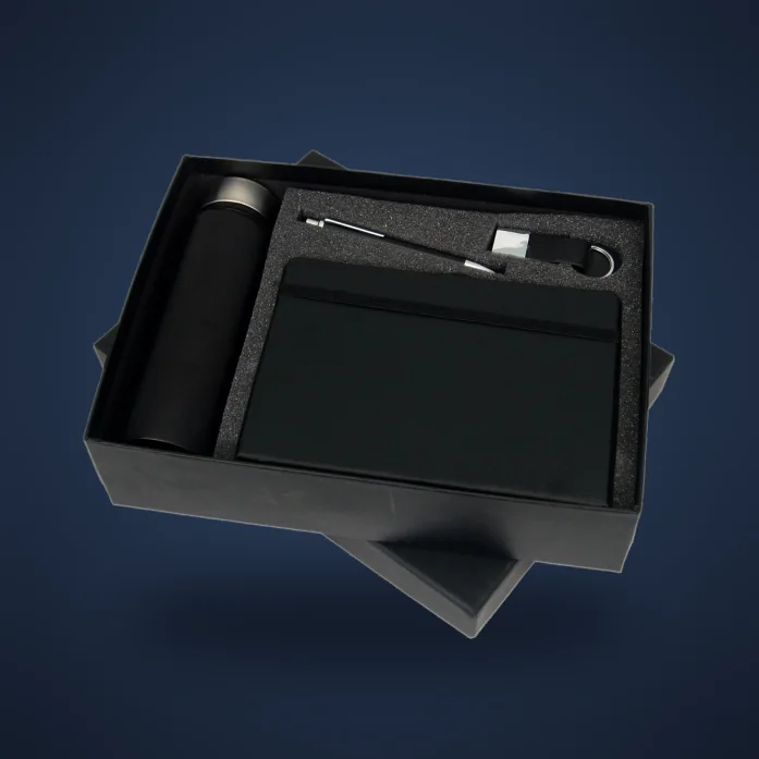 Employee welcome kit with a black bottle, notebook, pen and keychain in a black box